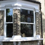 UPVC sash window frame with traditional timber finish